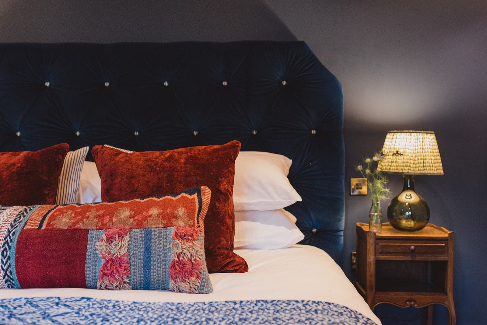 bed with lamp on side table