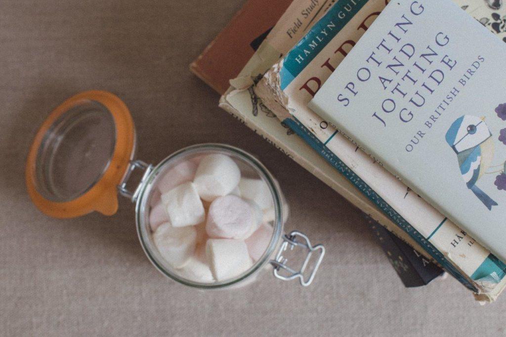 sweet jar next to pile of books