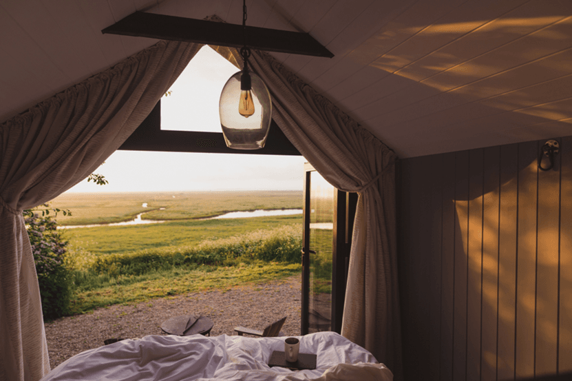 Picturesque view from the bed of one of our huts, looking out over the vast landscape of Elmley Nature Reserve