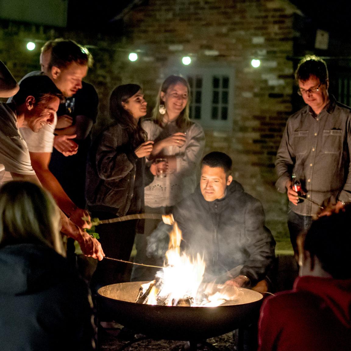 group of people around fire pit
