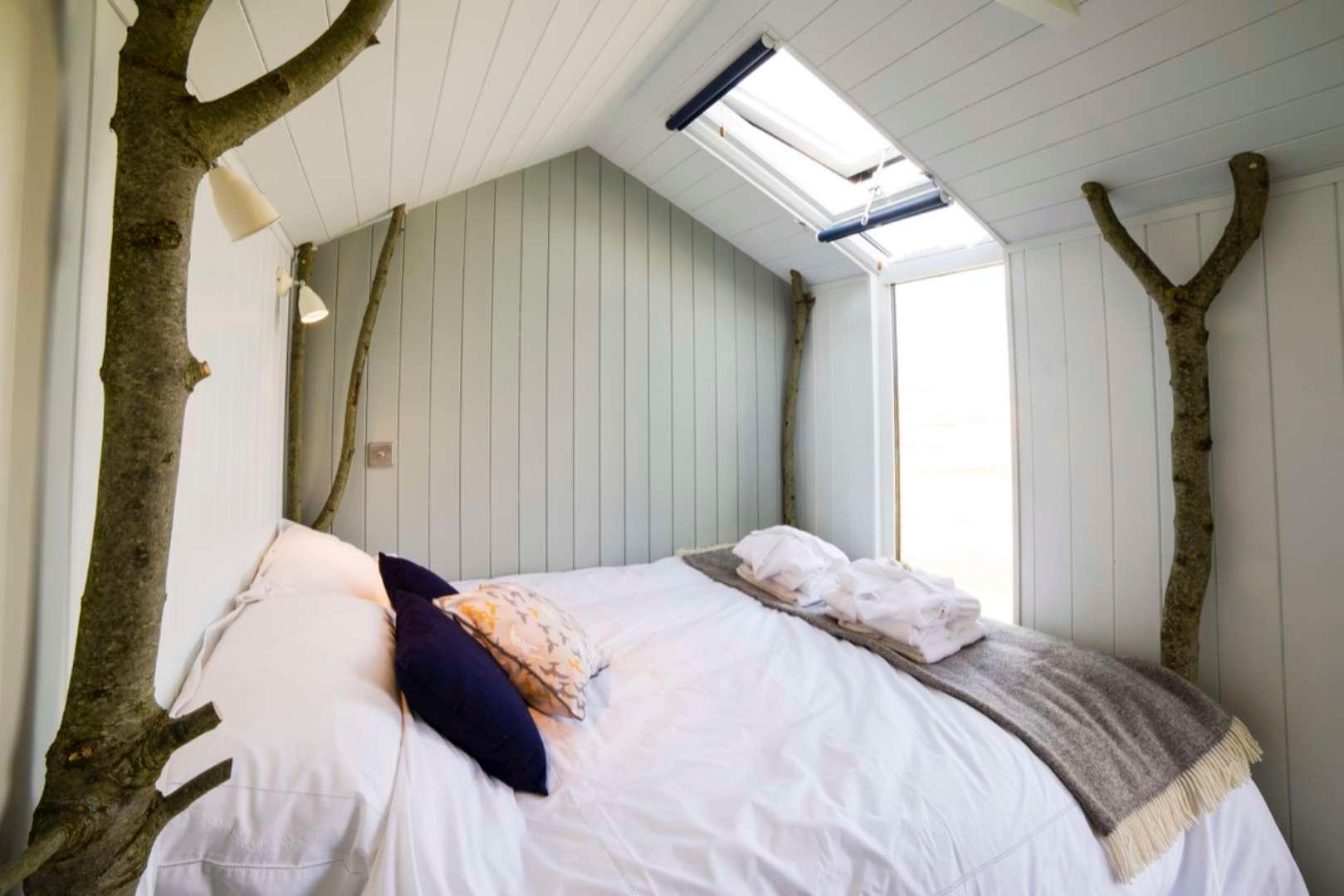 Bed with floor to roof window lights